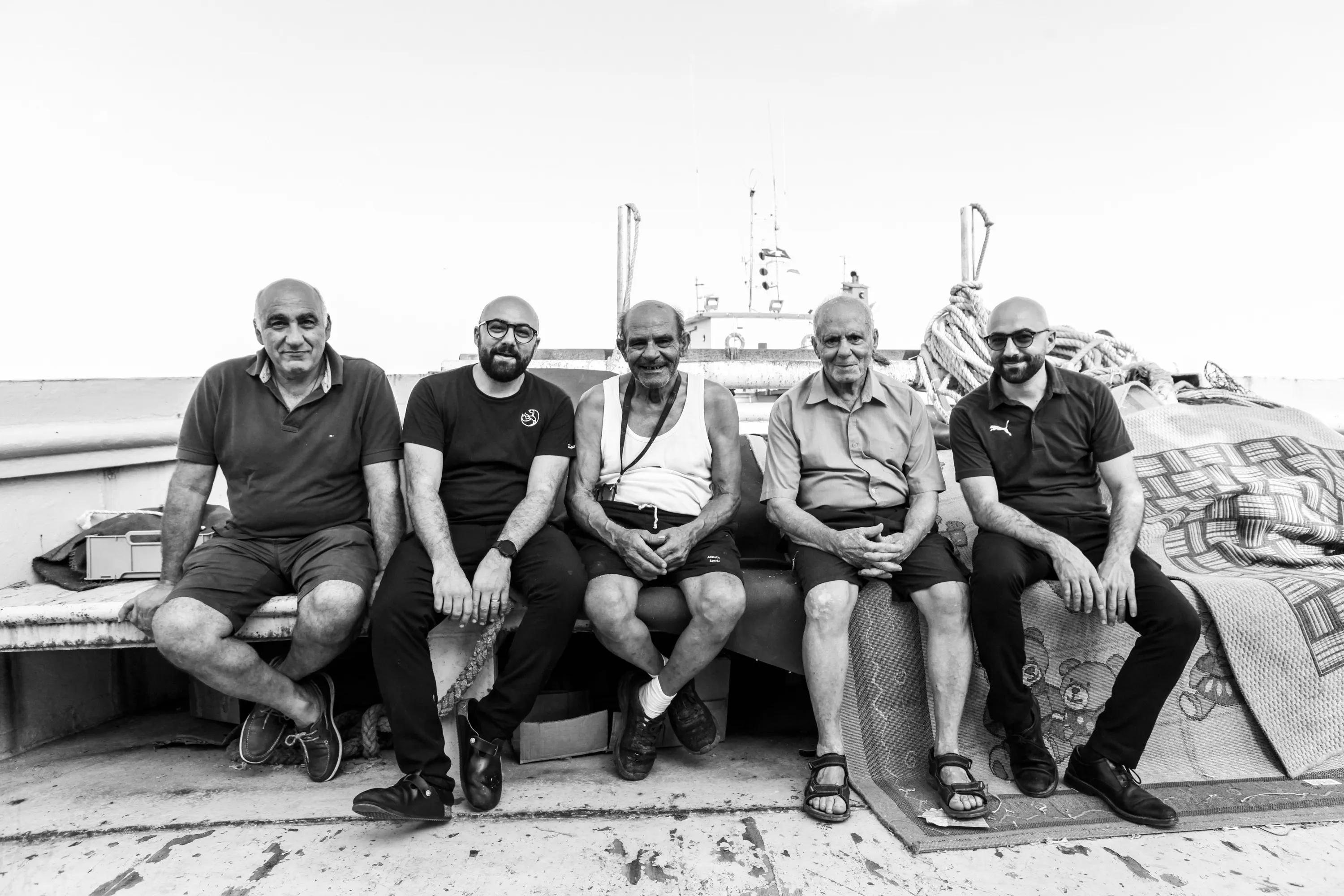 Three generations of the Tartarun family aboard a Marsaxlokk fishing boat